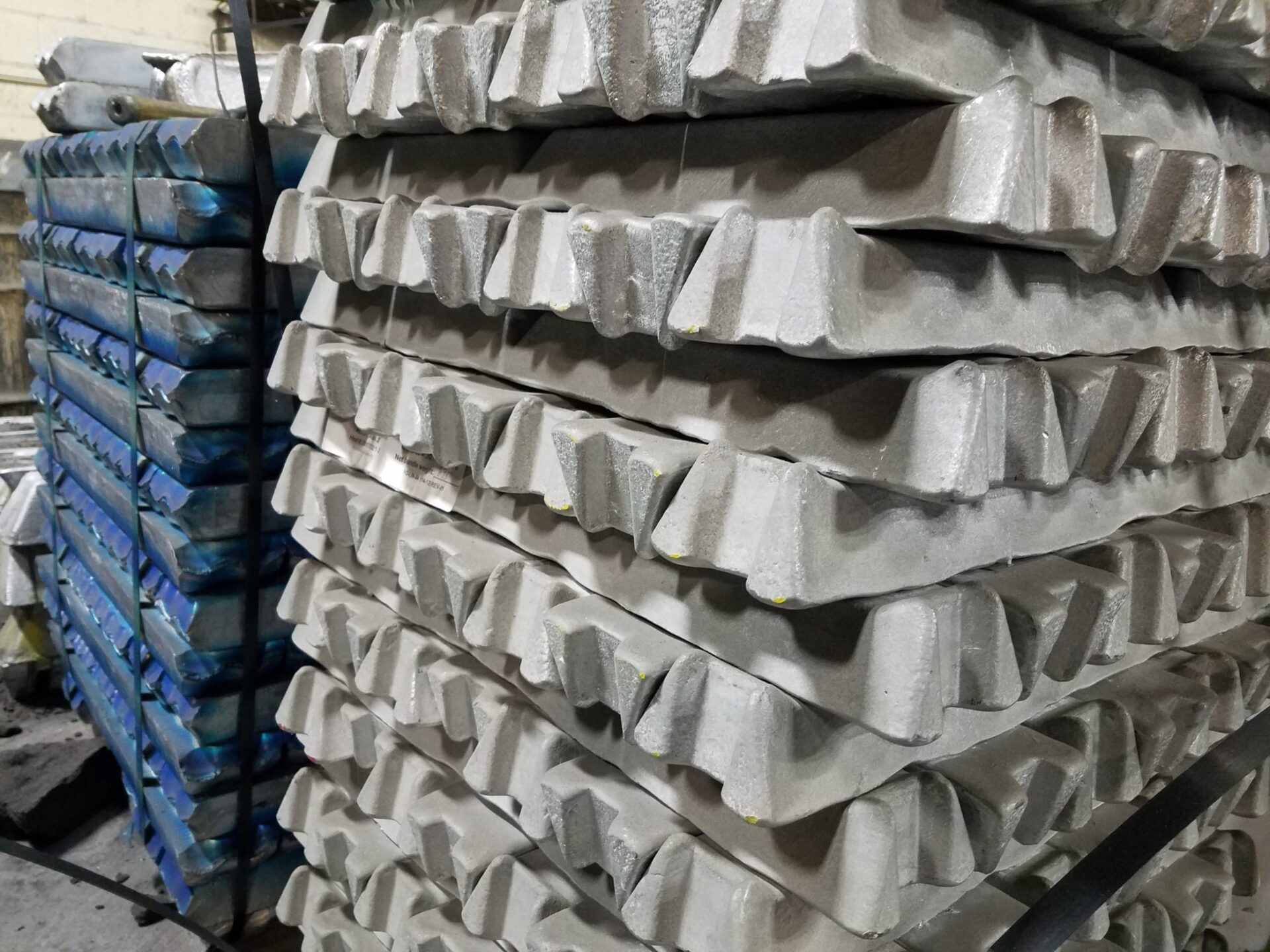 Stacks of silver and multicolor metal alloy ingots