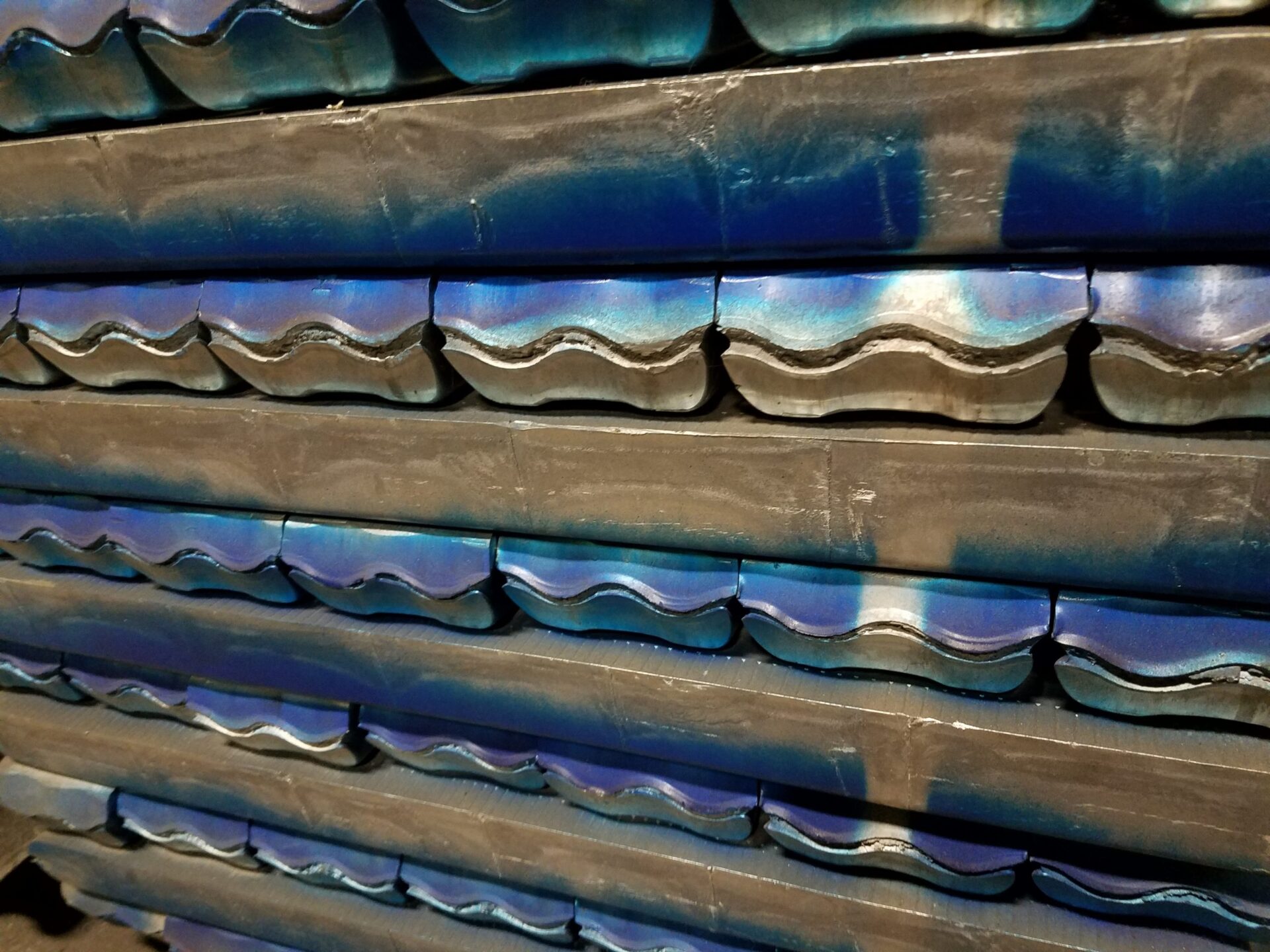 Gold and multicolor ingots of metal alloys in a row